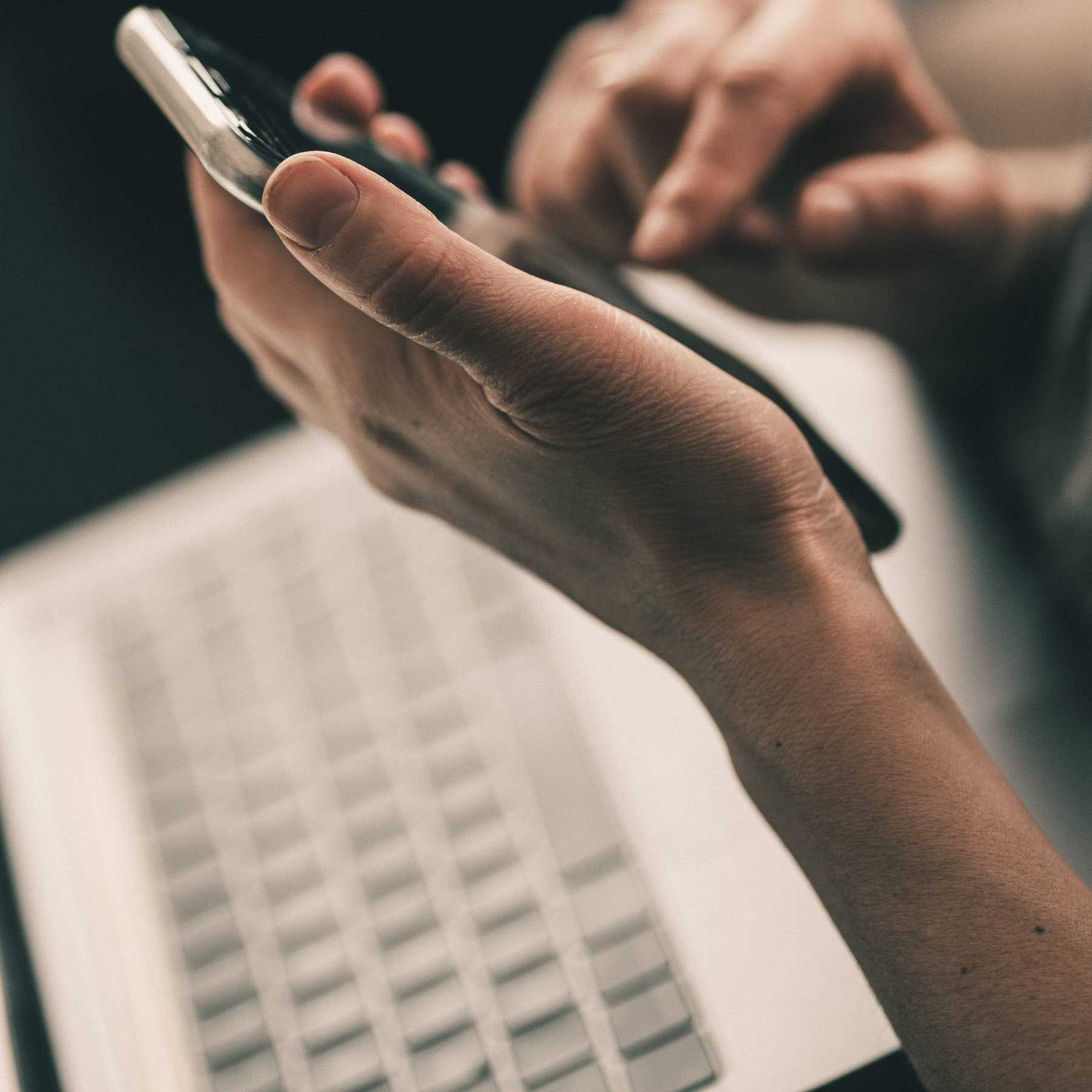 Close-up of a hand dialing a number on a phone